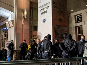 Philadelphia police officers gather at Pennsylvania Convention Center after probing an alleged plot to attack a vote counting in Philadelphia November 6, 2020.