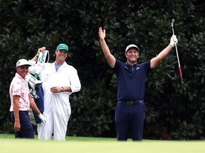 Jon Rahm celebrates with Rickie Fowler after skipping in for a hole in one on the 16th during a practice round prior to the Masters at Augusta National Golf Club on November 10, 2020.