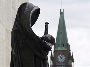 The Peace Tower on Parliament Hill is seen behind the justice statue outside the Supreme Court of Canada in Ottawa, Monday June 6, 2016.