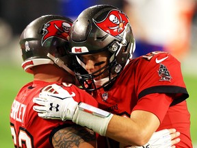 A.Q. Shipley (left) of the Tampa Bay Buccaneers talks with Tom Brady before the game against the New Orleans Saints at Raymond James Stadium on November 8, 2020 in Tampa.