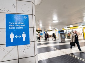 A sign reminding people to respect social distancing is seen at the Central Station in Stockholm, Sweden November 9, 2020.