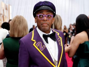Director Spike Lee, wearing a coat with the number 24 in memory of NBA player Kobe Bryant, poses on the red carpet during the Oscars arrivals at the 92nd Academy Awards in Hollywood, Calif., Feb. 9, 2020.