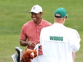 Tiger Woods has a laugh on the practice range on Tuesday ahead of this week's Masters at Augusta National.
