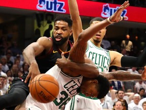 Tristan Thompson of the Cleveland Cavaliers competes for the ball against Marcus Smart and Jayson Tatum of the Boston Celtics in the second quarter during Game 6 of the 2018 NBA Eastern Conference Finals at Quicken Loans Arena on May 25, 2018 in Cleveland, Ohio.