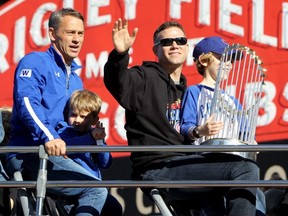 Theo Epstein waves to the crowd during a World Series victory parade for the Cubs in Chicago, Nov. 4, 2016.