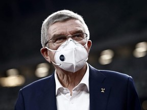 International Olympic Committee President Thomas Bach, wearing a face mask, speaks to the media during a visit to the National Stadium, main venue for the postponed Tokyo 2020 Olympic and Paralympic Games, in Tokyo, Tuesday, Nov. 17, 2020.