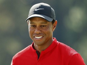 Tiger Woods reacts after finishing on the 18th green during the final round of The Masters at Augusta National Golf Club in Augusta, Ga., Sunday, Nov. 15, 2020.