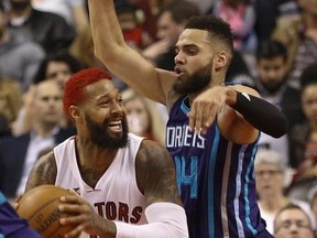 Toronto Raptors' James Johnson is guarded by Charlotte Hornets Michael Kidd-Gilchrist in the fourth quarter. Raptors  defeated  Charlotte Hornets 92-87 in Toronto, Ont. on Wednesday April 15, 2015.