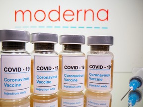Vials with a sticker reading, "COVID-19 / Coronavirus vaccine / Injection only" are seen in front of a Moderna logo in this illustration taken October 31, 2020.