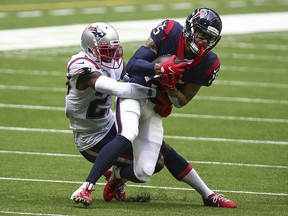 Houston Texans wide receiver Will Fuller (15) makes a reception as New England Patriots defensive back J.C. Jackson (27) attempts to make a tackle at NRG Stadium.
