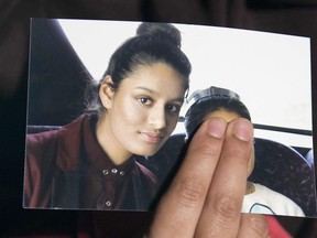 In this file photo taken on February 22, 2015 Renu, eldest sister of missing British girl Shamima Begum, holds a picture of her sister while being interviewed by the media in central London, on February 22, 2015.