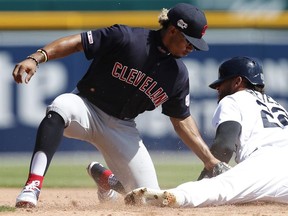 Cleveland Indians shortstop Francisco Lindor (12) tags out Detroit Tigers left fielder Victor Reyes (22) at second base during the sixth inning at Comerica Park.