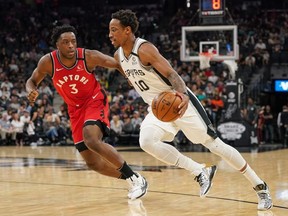 San Antonio Spurs forward DeMar DeRozan moves past Toronto Raptors forward OG Anunoby in the first half at the AT&T Center.