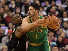 Toronto Raptors center Serge Ibaka tries to knock the ball away from Boston Celtics center Enes Kanter in the first half at Scotiabank Arena.