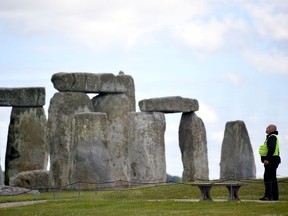 A security officer patrols around the perimeter Stonehenge stone circle, near Amesbury, Britain June 20, 2020.