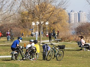 People enjoy the warm weather along the lakeshore, Monday, Nov. 9, 2020 in Montreal.
