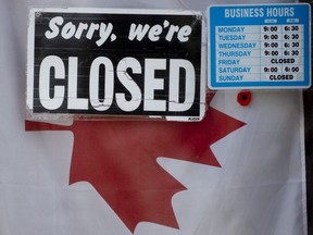 A "closed" sign hangs in a store window in Ottawa, Thursday April 16, 2020.