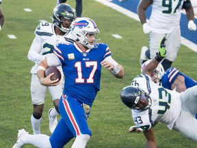 Nov 8, 2020; Orchard Park, New York, USA; Buffalo Bills quarterback Josh Allen (17) runs for a touchdown against the Seattle Seahawks in the fourth quarter at Bills Stadium.