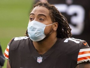 Cleveland Browns tackle Kendall Lamm wears a mask while on the sideline during the second quarter against the Houston Texans at FirstEnergy Stadium.