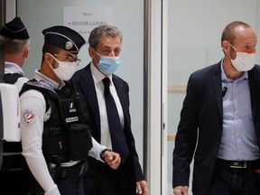 Former French President Nicolas Sarkozy leaves after an interruption in his trial on charges of corruption and influence peddling, at Paris courthouse, France, November 23, 2020.