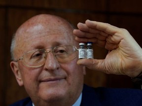Alexander Gintsburg, director of the Gamaleya National Research Center for Epidemiology and Microbiology, shows bottles with Sputnik-V vaccine against the coronavirus disease (COVID-19) during an interview with Reuters in Moscow, Russia September 24, 2020.
