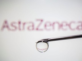 AstraZeneca's logo is reflected in a drop on a syringe needle in this illustration taken November 9, 2020.