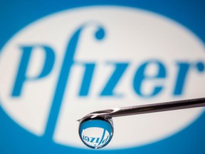 Pfizer's logo is reflected in a drop on a syringe needle in this illustration taken Nov. 9, 2020.