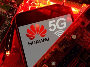 A smartphone with the Huawei and 5G network logo is seen on a PC motherboard in this illustration picture taken Jan. 29, 2020.
