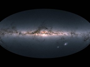 A handout photo released on April 25, 2018 by the European Space Agency shows Gaia's all-sky view of our Milky Way Galaxy and neighbouring galaxies, based on measurements of nearly 1.7 billion stars. The map shows the total brightness and colour of stars observed by the ESA satellite in each portion of the sky between July 2014 and May 2016. Brighter regions indicate denser concentrations of especially bright stars, while darker regions correspond to patches of the sky where fewer bright stars are observed. The colour representation is obtained by combining the total amount of light with the amount of blue and red light recorded by Gaia in each patch of the sky. (AFP PHOTO/EUROPEAN SPACE AGENCY/GAIA /DPAC)