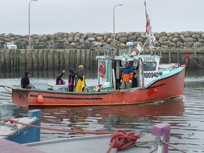 Indigenous fishermen head from the harbour in Saulnierville, N.S. on Wednesday, Oct. 21, 2020.
