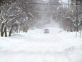 A lone truck makes its way along a snowy road in Owen Sound, Ont., Feb. 28, 2020.