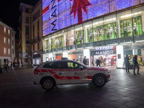 A police car in the area where a stabbing occurred in the department store, in Lugano, Switzerland, Tuesday, Nov. 24, 2020.