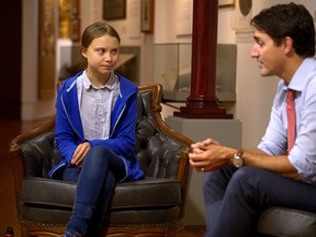 Prime Minister Justin Trudeau greets Swedish climate change teen activist Greta Thunberg before a climate strike march in Montreal on Sept. 27, 2019.