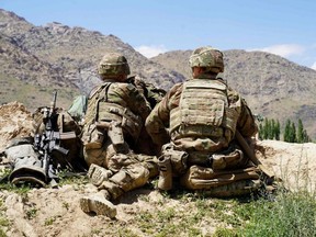 In this file photo taken June 6, 2019, U.S. soldiers look out over hillsides during a visit of the commander of U.S. and NATO forces in Afghanistan General Scott Miller at the Afghan National Army checkpoint in Nerkh district of Wardak province.