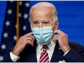 U.S. President-elect Joe Biden adjusts his face mask after speaking about the U.S. economy following a briefing with economic advisers in Wilmington, Delaware, U.S., Nov. 16, 2020.