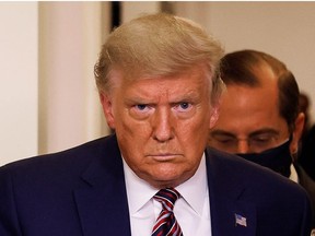 U.S. President Donald Trump is followed by HHS Secretary Alex Azar as he arrives to speak about prescription drug prices during an appearance in the Brady Press Briefing Room at the White House in Washington, U.S., November 20, 2020.