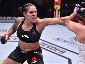 In this handout provided by UFC, (L-R) Amanda Nunes of Brazil punches Felicia Spencer of Canada in their UFC featherweight championship bout during the UFC 250 event at UFC APEX on June 06, 2020 in Las Vegas, Nevada.
