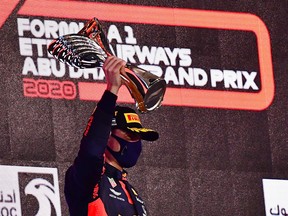 Red Bull's Max Verstappen celebrates winning the Abu Dhabi Grand Prix on the podium in Abu Dhabi, United Arab Emirates, Dec. 13, 2020.