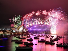 Fireworks explode over the Sydney Opera House and Sydney Harbour Bridge during downsized New Year's Eve celebrations during the COVID-19 pandemic, in Australia, Jan. 1, 2021.