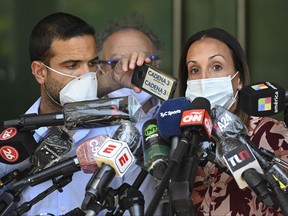 Therapists treating Argentina former football star and current coach of Gimnasia de La Plata football team Diego Maradona, psychiatrist Agustina Cosachov (right) and psychologist Carlos Diaz, talk to members of the media at the private clinic where Maradona underwent a brain surgery for a blood clot, in Olivos, Buenos Aires province, on Nov. 6, 2020.