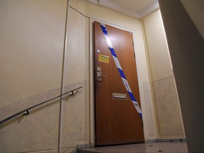 Barrier tape of the police is fixed on the door of an apartment in Haninge, south of Stockholm, on Dec. 1, 2020, one day after a man in his 40s who was kept locked by his mother was found there.