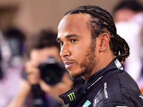 In this file photo taken on Nov. 29, 2020, Mercedes' British driver Lewis Hamilton looks on after winning the Bahrain Formula One Grand Prix at the Bahrain International Circuit in the city of Sakhir.
