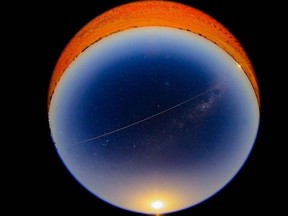 This handout photograph taken and released by the Japan Aerospace Exploration Agency (JAXA) on December 6, 2020 shows a scine of JAXA's Hayabusa-2 probe's sample dropping to earth after landing on and gathering material from an asteroid some 300 million kilometres from Earth, seen from Coober Pedy in South Australia.