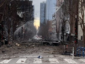 In this photo from the Twitter page of the Nashville Fire Department, damage is seen on a street after an explosion in Nashville, Tenn., on Dec. 25, 2020.