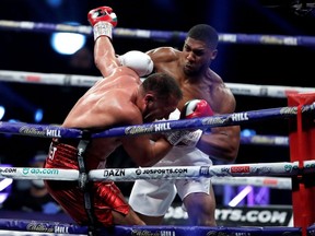 Anthony Joshua (white trunks) in action against Kubrat Pulev (red trunks) in a heavyweight world title fight at the SSE Arena in London, England, Saturday, Dec. 12, 2020.