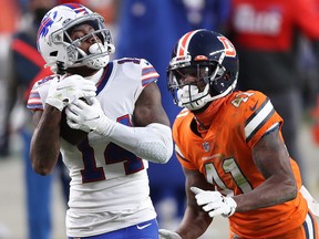 Stefon Diggs of the Buffalo Bills makes a reception past De'Vante Bausby of the Denver Broncos at Empower Field At Mile High on December 19, 2020 in Denver.