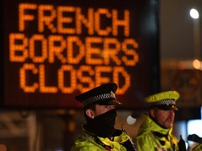 Police officers block access to the port in Dover, south east England on December 22, 2020, after France closed its borders to accompanied freight arriving from the UK due to the rapid spread of a new coronavirus strain.