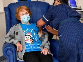 Margaret Keenan, 90, is the first patient in Britain to receive the Pfizer/BioNtech COVID-19 vaccine at University Hospital, administered by nurse May Parsons, at the start of the largest ever immunization program in the British history, in Coventry, December 8, 2020.
