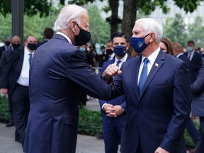 Former U.S. Vice President Joe Biden (left) and U.S. Vice President Mike Pence (right) greet each other at ceremonies marking the 19th anniversary of the Sept. 11, 2001 terrorist attacks on the World Trade Center at the 911 Memorial & Museum in the Manhattan borough of New York City, Sept 11, 2020.