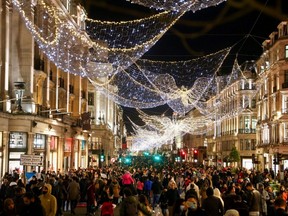 Shoppers walk down pedestrianized Regent Street, amid the COVID-19 outbreak, in London, England, Dec. 5, 2020.